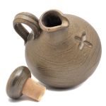 Hand-potted brown holy water jug
